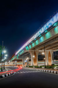 Illuminated light trails on road at night