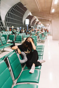 High angle view of woman sitting on chair