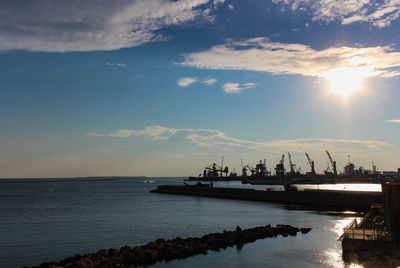 Pier over sea against sky during sunset