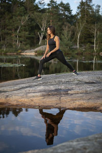 Woman at lake stretching