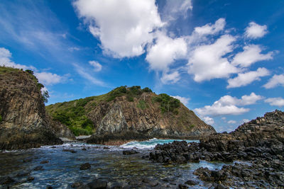 Scenic view of sea and mountains against sky