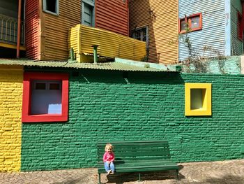 Full length of a woman standing against building