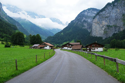 Scenic view of mountains and houses against sky