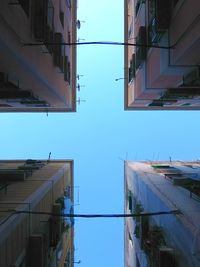 Low angle view of buildings against clear blue sky