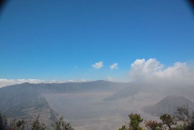 Scenic view of mountains against blue sky