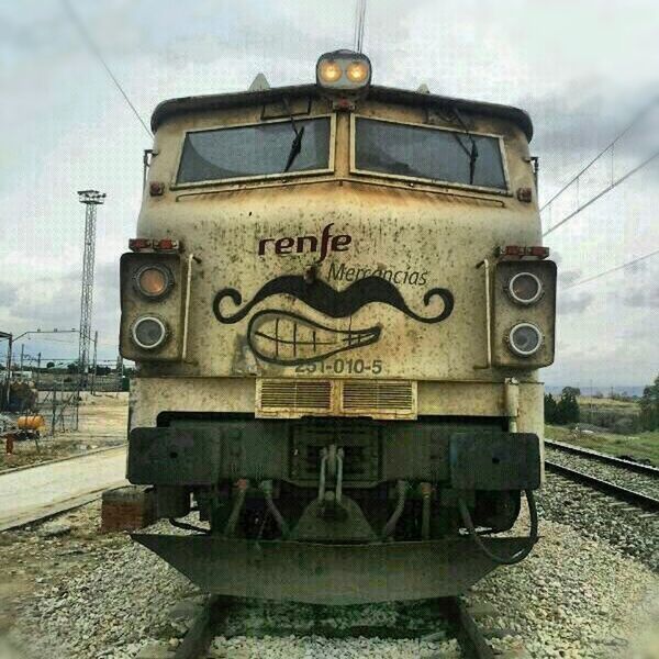 transportation, mode of transport, railroad track, rail transportation, land vehicle, sky, public transportation, train - vehicle, car, day, text, communication, power line, western script, outdoors, no people, railroad station, building exterior, cloud - sky, old-fashioned