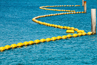 High angle view of yellow buoys on sea