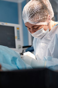 Midsection of doctor examining patient in hospital