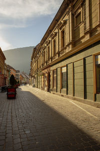 Street amidst buildings against sky in city