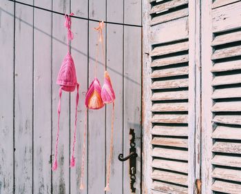 Close-up of pink door hanging on wall