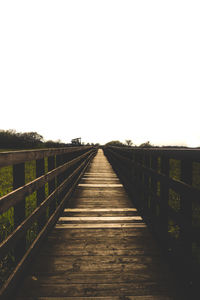 Footbridge against clear sky