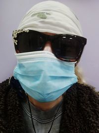 Portrait of man covering face with sunglasses