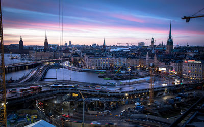 High angle view of illuminated cityscape against sky during sunset