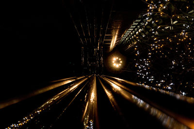 Light trails in illuminated tunnel at night
