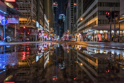 Illuminated city street and buildings at night