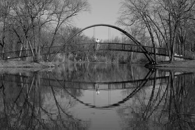 Reflection of bare trees in river