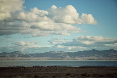 Scenic view of sea and mountains against sky