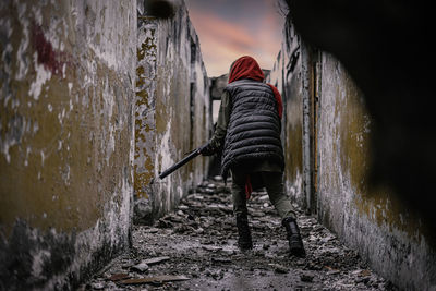 Rear view of woman walking on wall