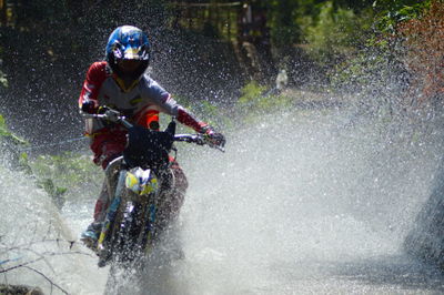 Man riding motorcycle on water