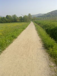 Empty road along countryside landscape