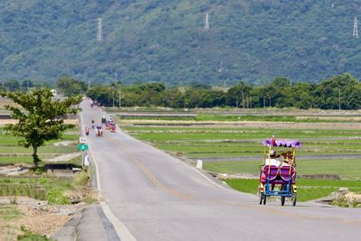 People riding motorcycle on road