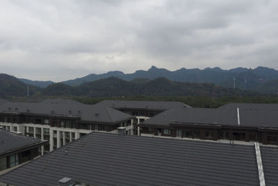 Houses in city against sky