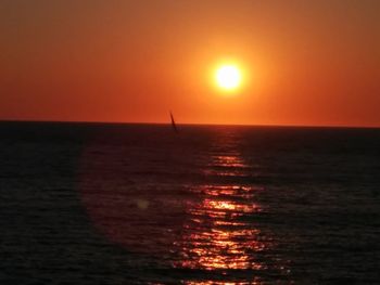 Scenic view of sea against orange sky