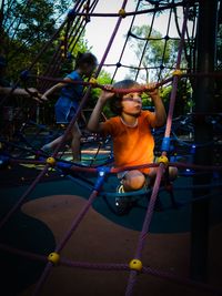 Boy climbing rope at playground