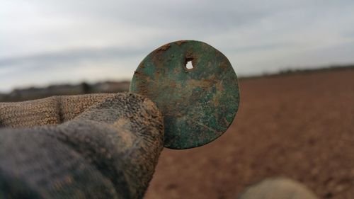 Close-up of rusty metal against sky