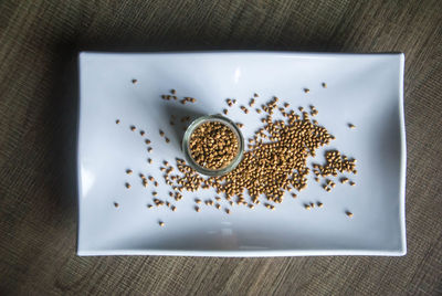 High angle view of coffee beans in plate