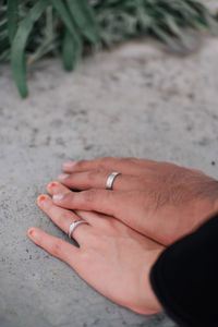 Holding hands with engagement ring on finger