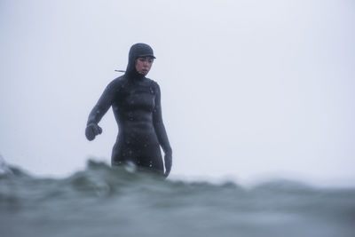 Woman surfing during winter snow