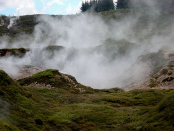 Scenic view of waterfall against sky