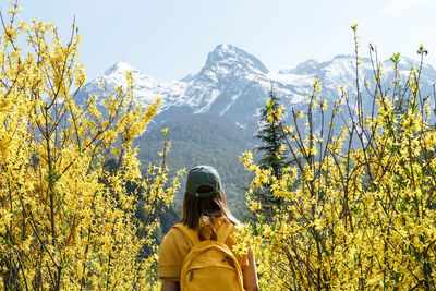 Rear view of woman walking on mountain