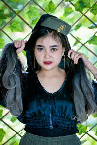 Portrait of beautiful young woman standing outdoors