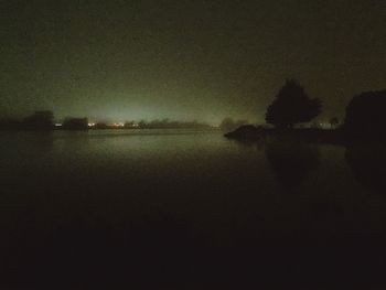 Reflection of trees in water at night