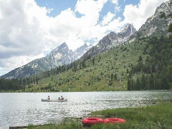 Boats in lake with mountains in background