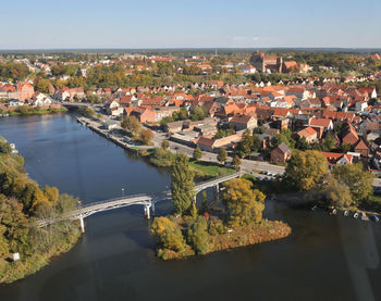 High angle view of bridge over river amidst buildings in city