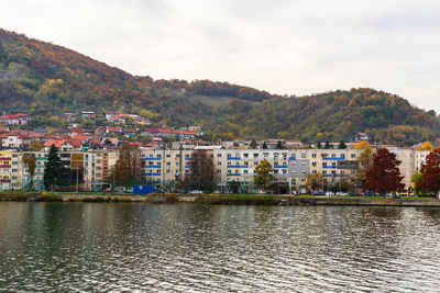 Townscape by lake against sky in town