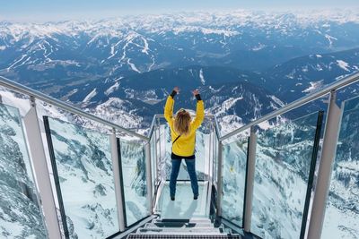 Full length of man standing on snow covered mountain