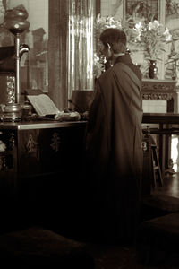 Rear view of woman reading book