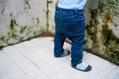 Low section of man standing on footpath