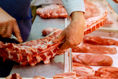 Midsection of person preparing food on table