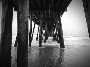 Silhouette of pier on sea against sky