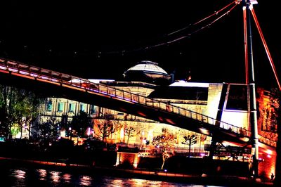 Low angle view of illuminated ferris wheel at night