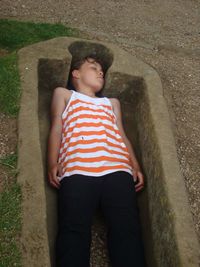 High angle view of boy sleeping in grave at whitby abbey