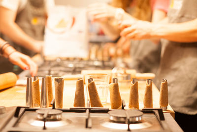 Pastry dough on cooling rack with bakers in background