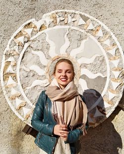 Portrait of smiling young woman standing in winter