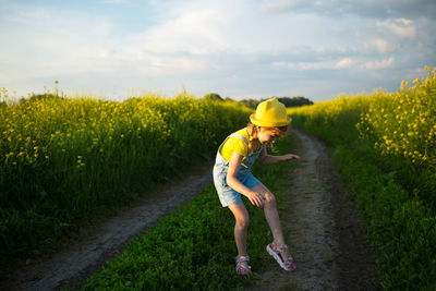 Woman with yellow umbrella on field