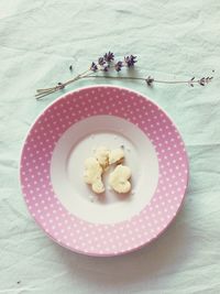 High angle view of cookie in plate by lavender on table